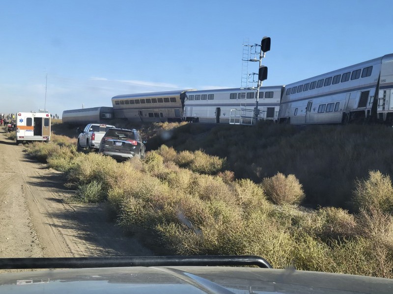 In this photo provided by Kimberly Fossen people work at the scene of an Amtrak train derailment on Saturday, Sept. 25, 2021, in north-central Montana. Multiple people were injured when the train that runs between Seattle and Chicago derailed Saturday, the train agency said. (Kimberly Fossen via AP)
