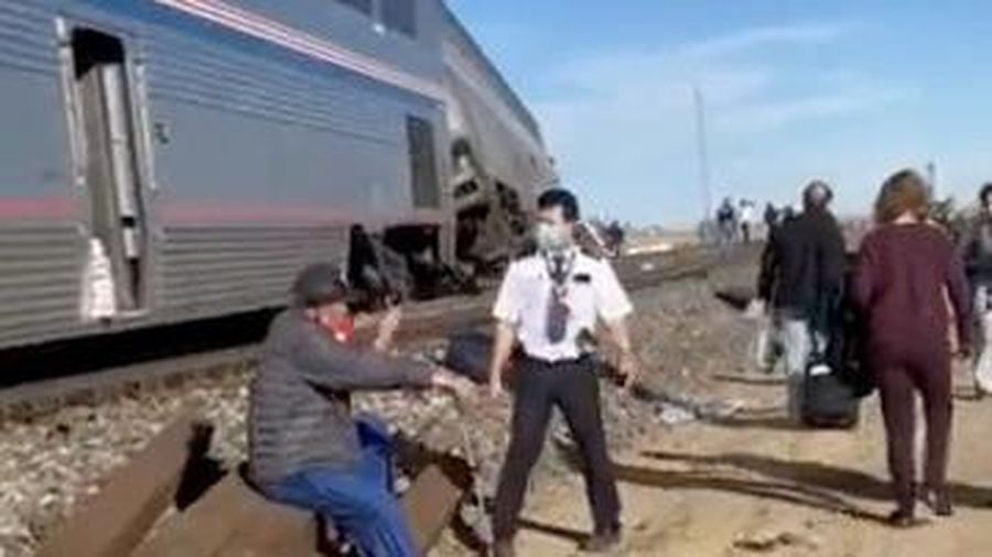 In this photo provided by Kimberly Fossen people work at the scene of an Amtrak train derailment on Saturday, Sept. 25, 2021, in north-central Montana. Multiple people were injured when the train that runs between Seattle and Chicago derailed Saturday, the train agency said. (Kimberly Fossen via AP)