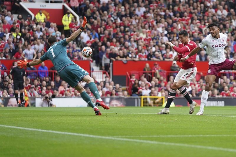 Manchester United's Cristiano Ronaldo, center, in action during the English Premier League soccer match between Manchester United and Aston Villa at the Old Trafford stadium in Manchester, England, Saturday, Sept 25, 2021. (AP Photo/Jon Super)
