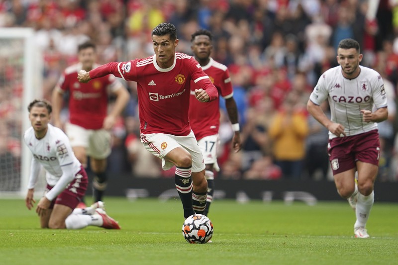 Manchester United's Cristiano Ronaldo, center, in action during the English Premier League soccer match between Manchester United and Aston Villa at the Old Trafford stadium in Manchester, England, Saturday, Sept 25, 2021. (AP Photo/Jon Super)