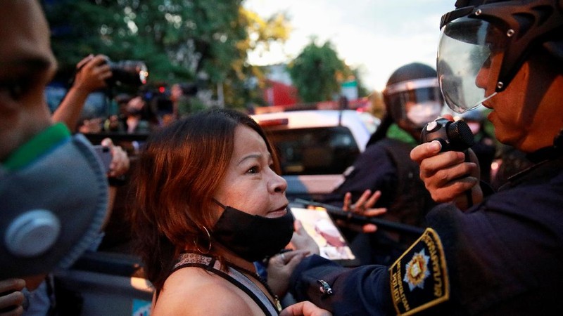 SENSITIVE MATERIAL. THIS IMAGE MAY OFFEND OR DISTURB  A demonstrator reacts in front of police during a protest over the Thai government's handling of the coronavirus disease (COVID-19) pandemic and to demand Prime Minister Prayuth Chan-ocha's resignation, in Bangkok, Thailand, September 28, 2021. REUTERS/Soe Zeya Tun