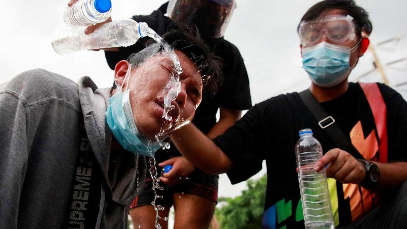 SENSITIVE MATERIAL. THIS IMAGE MAY OFFEND OR DISTURB  A demonstrator reacts in front of police during a protest over the Thai government's handling of the coronavirus disease (COVID-19) pandemic and to demand Prime Minister Prayuth Chan-ocha's resignation, in Bangkok, Thailand, September 28, 2021. REUTERS/Soe Zeya Tun