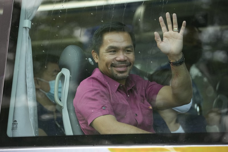 Supporters of retired Filipino boxing star and senator Manny Pacquiao gather near an area where he will file his certificate of candidacy for next year's presidential elections before the Commission on Elections on Friday, Oct. 1, 2021 in Manila, Philippines. Friday marks the start of a weeklong registration period for candidates seeking to lead a Southeast Asian nation that has been hit hard by the pandemic and deep political conflicts.(AP Photo/Aaron Favila)