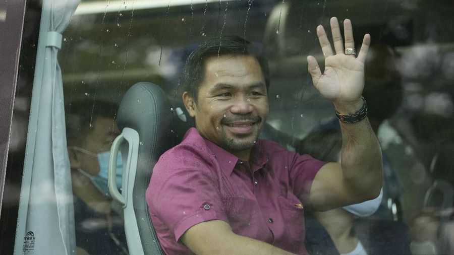 Supporters of retired Filipino boxing star and senator Manny Pacquiao gather near an area where he will file his certificate of candidacy for next year's presidential elections before the Commission on Elections on Friday, Oct. 1, 2021 in Manila, Philippines. Friday marks the start of a weeklong registration period for candidates seeking to lead a Southeast Asian nation that has been hit hard by the pandemic and deep political conflicts.(AP Photo/Aaron Favila)