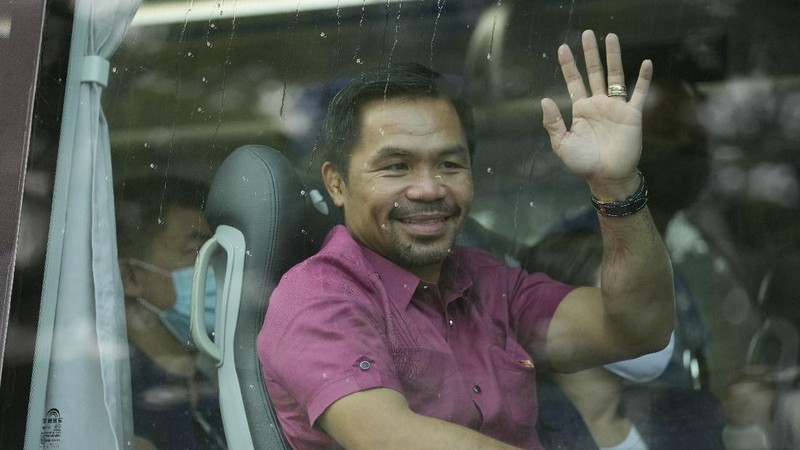 Supporters of retired Filipino boxing star and senator Manny Pacquiao gather near an area where he will file his certificate of candidacy for next year's presidential elections before the Commission on Elections on Friday, Oct. 1, 2021 in Manila, Philippines. Friday marks the start of a weeklong registration period for candidates seeking to lead a Southeast Asian nation that has been hit hard by the pandemic and deep political conflicts.(AP Photo/Aaron Favila)