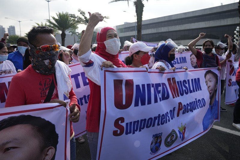 Philippines Elections Supporters of retired Filipino boxing star and senator Manny Pacquiao gather near an area where he will file his certificate of candidacy for next year's presidential elections before the Commission on Elections on Friday, Oct. 1, 2021 in Manila, Philippines. Friday marks the start of a weeklong registration period for candidates seeking to lead a Southeast Asian nation that has been hit hard by the pandemic and deep political conflicts.(AP Photo/Aaron Favila)