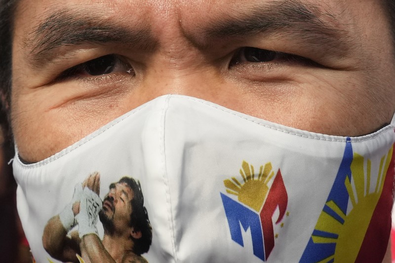 Supporters of retired Filipino boxing star and senator Manny Pacquiao gather near an area where he will file his certificate of candidacy for next year's presidential elections before the Commission on Elections on Friday, Oct. 1, 2021 in Manila, Philippines. Friday marks the start of a weeklong registration period for candidates seeking to lead a Southeast Asian nation that has been hit hard by the pandemic and deep political conflicts.(AP Photo/Aaron Favila)