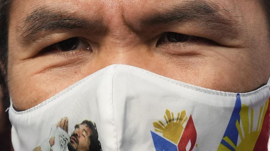 Supporters of retired Filipino boxing star and senator Manny Pacquiao gather near an area where he will file his certificate of candidacy for next year's presidential elections before the Commission on Elections on Friday, Oct. 1, 2021 in Manila, Philippines. Friday marks the start of a weeklong registration period for candidates seeking to lead a Southeast Asian nation that has been hit hard by the pandemic and deep political conflicts.(AP Photo/Aaron Favila)