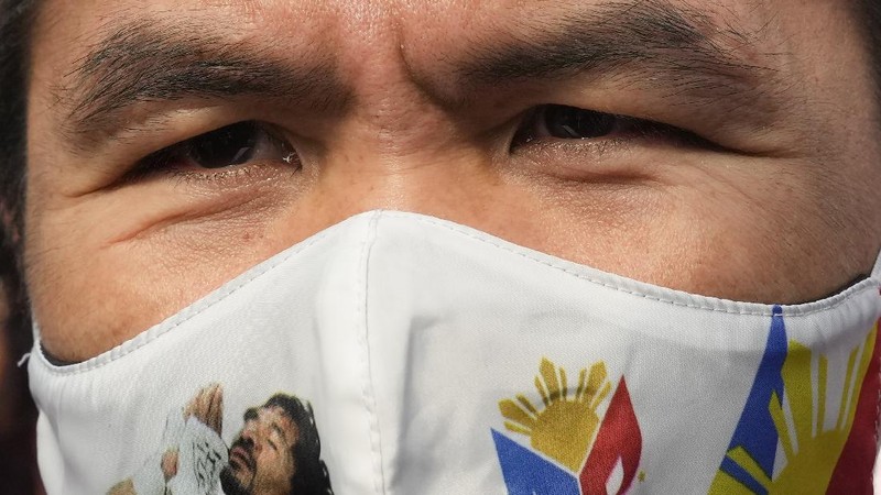 Supporters of retired Filipino boxing star and senator Manny Pacquiao gather near an area where he will file his certificate of candidacy for next year's presidential elections before the Commission on Elections on Friday, Oct. 1, 2021 in Manila, Philippines. Friday marks the start of a weeklong registration period for candidates seeking to lead a Southeast Asian nation that has been hit hard by the pandemic and deep political conflicts.(AP Photo/Aaron Favila)