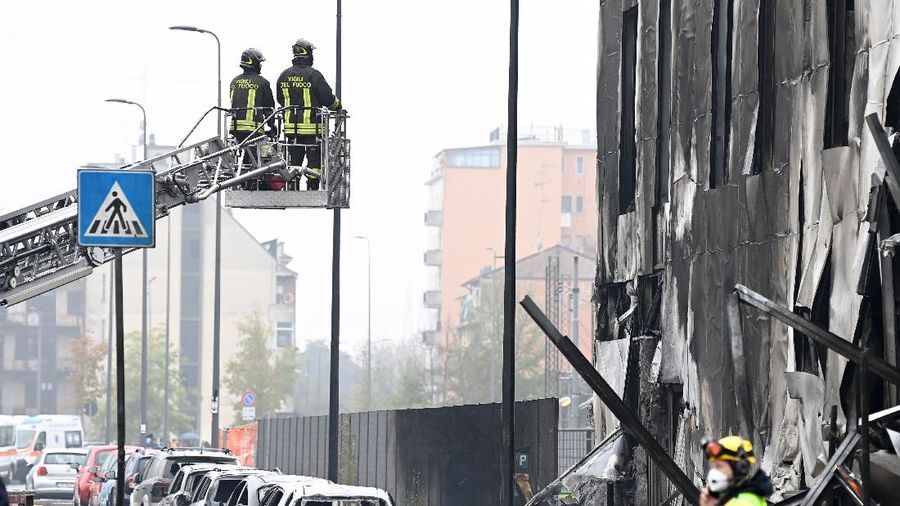 Fire fighters work at the scene where a small plane crashed into a building in San Donato Milanese, Italy, October 3, 2021. REUTERS/Flavio Lo Scalzo