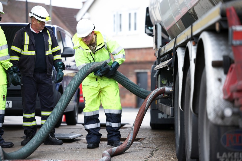A member of the military drives an oil tanker out of the Esso fuel services in Purfleet, Britain, October 5, 2021. REUTERS/Hannah McKay