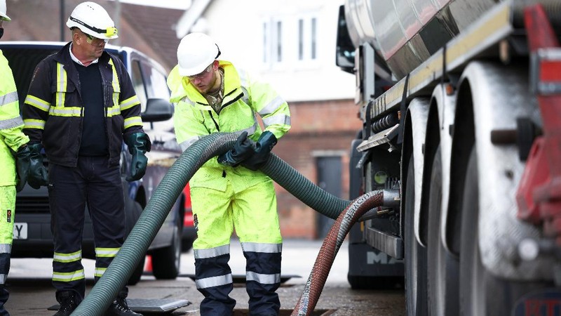 A member of the military drives an oil tanker out of the Esso fuel services in Purfleet, Britain, October 5, 2021. REUTERS/Hannah McKay