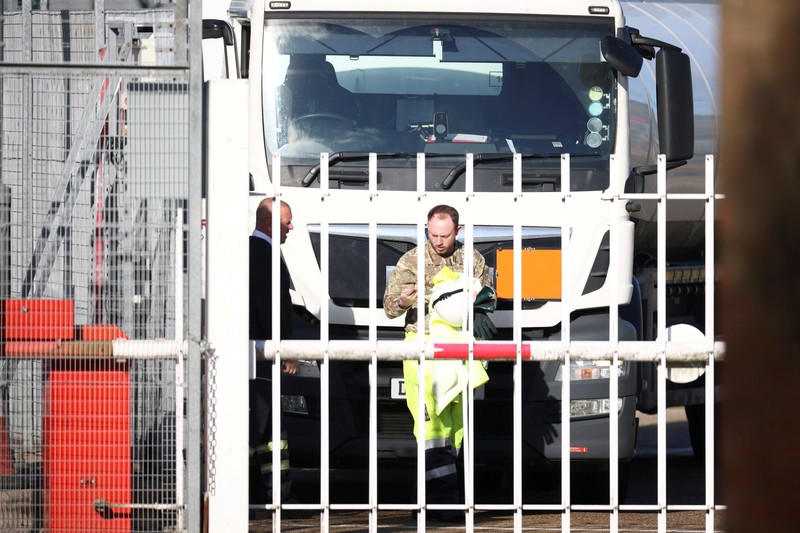 BRITAIN-TRUCKERS/ A member of the military drives an oil tanker out of the Esso fuel services in Purfleet, Britain, October 5, 2021. REUTERS/Hannah McKay