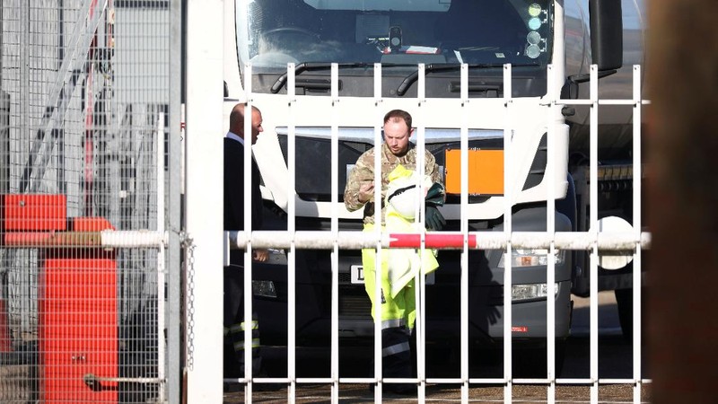 A member of the military drives an oil tanker out of the Esso fuel services in Purfleet, Britain, October 5, 2021. REUTERS/Hannah McKay