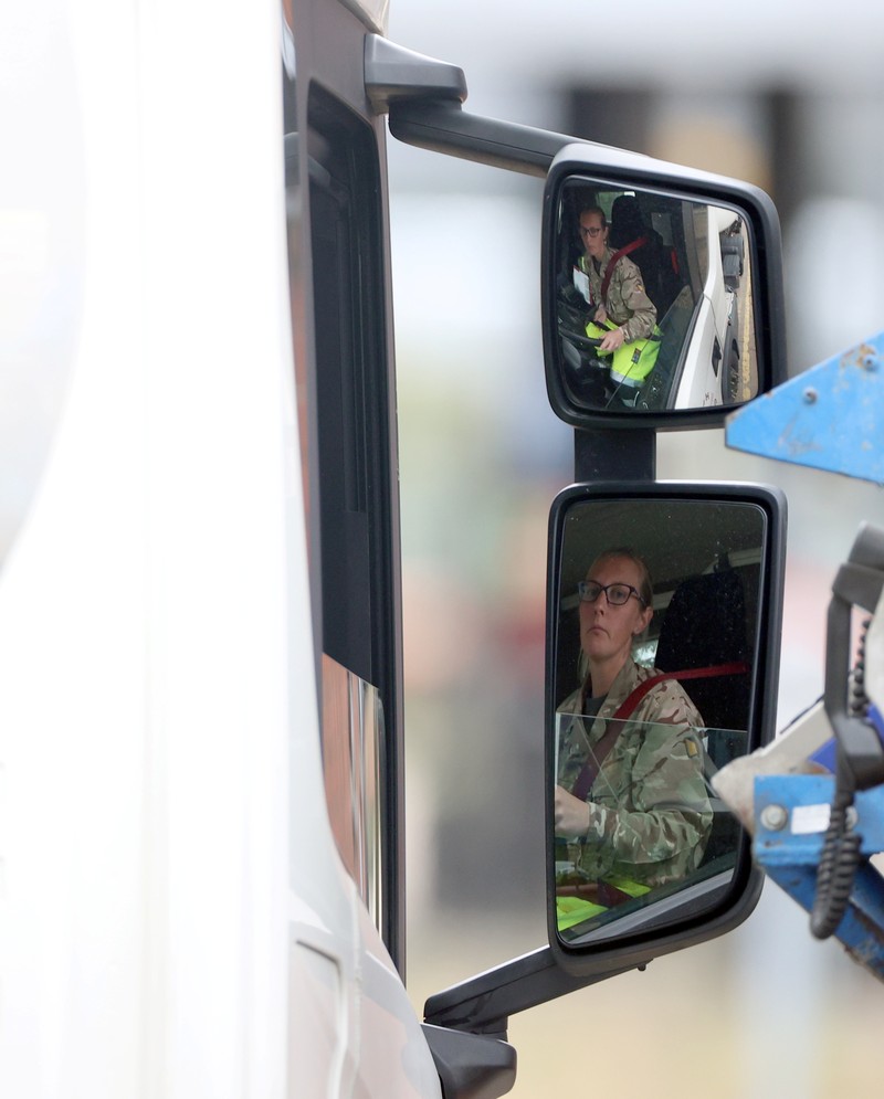 BRITAIN-TRUCKERS/ A member of the military drives an oil tanker out of the Esso fuel services in Purfleet, Britain, October 5, 2021. REUTERS/Hannah McKay