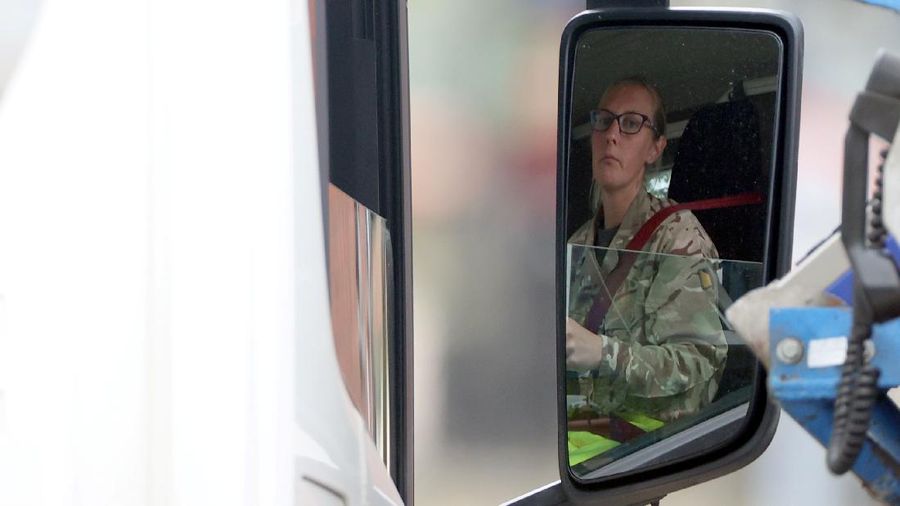 A member of the military drives an oil tanker out of the Esso fuel services in Purfleet, Britain, October 5, 2021. REUTERS/Hannah McKay