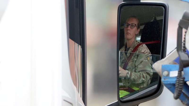 A member of the military drives an oil tanker out of the Esso fuel services in Purfleet, Britain, October 5, 2021. REUTERS/Hannah McKay