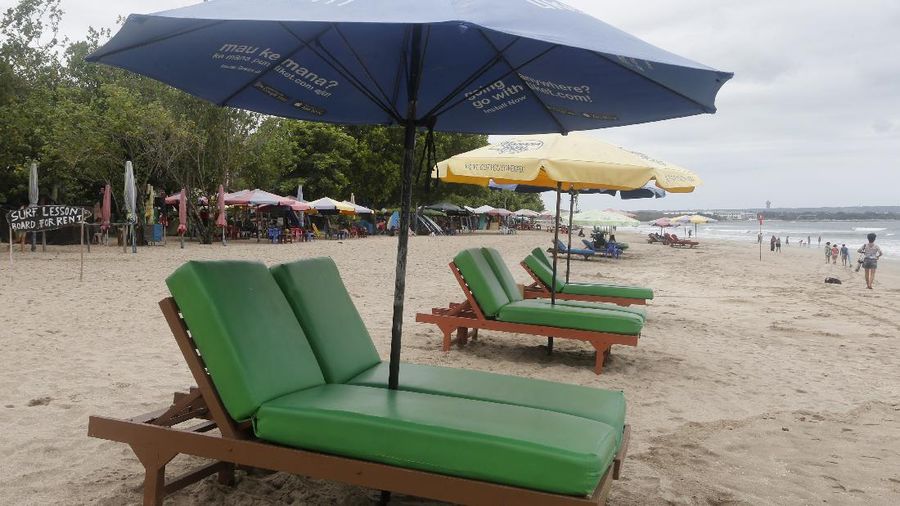 Empty sun chairs are placed at Kuta beach, Bali, Indonesia Wednesday, Oct. 6, 2021. Indonesia plans to reopen the airport in the resort island of Bali for international flights on Oct. 14, after closing it for more than a year because of the COVID-19 pandemic. (AP Photo/Firdia Lisnawati)