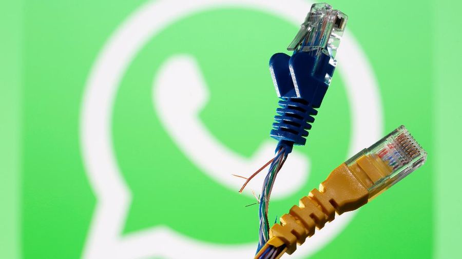 Broken Ethernet cables are seen in front of a displayed WhatsApp logo in this illustration taken October 5, 2021. REUTERS/Dado Ruvic/Illustration