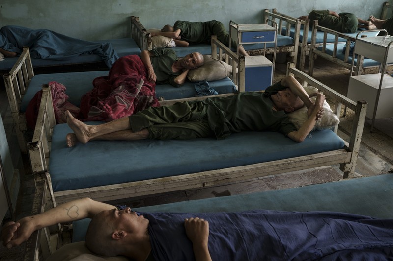 APTOPIX Afghanistan Drugs Drug users detained during a Taliban raid wait to be checked at a police station before being transferred to the Avicenna Medical Hospital for Drug Treatment in Kabul, Afghanistan, Friday, Oct. 1, 2021. At least 150 men were taken to the district police station, where all their belongings -- drugs, wallets, knifes, rings, lighters, a juice box -- were burned in a pile since they are forbidden to take them to the treatment center. (AP Photo/Felipe Dana)