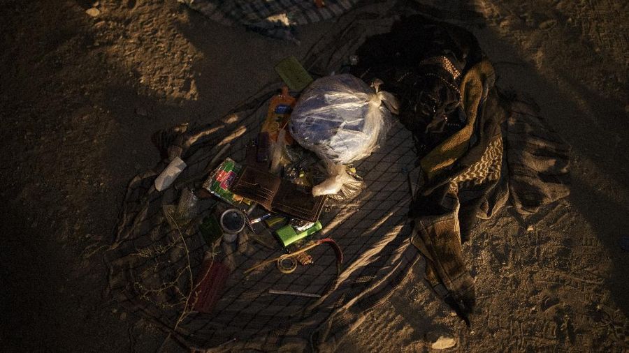The belongings removed from pockets of drug users detained during a Taliban raid lay on the ground of a police station in Kabul, Afghanistan, Friday, Oct. 1, 2021. At least 150 men were taken to the district police station, where all their belongings -- drugs, wallets, knifes, rings, lighters, a juice box -- were burned in a pile since they are forbidden to take them to the treatment center. (AP Photo/Felipe Dana)