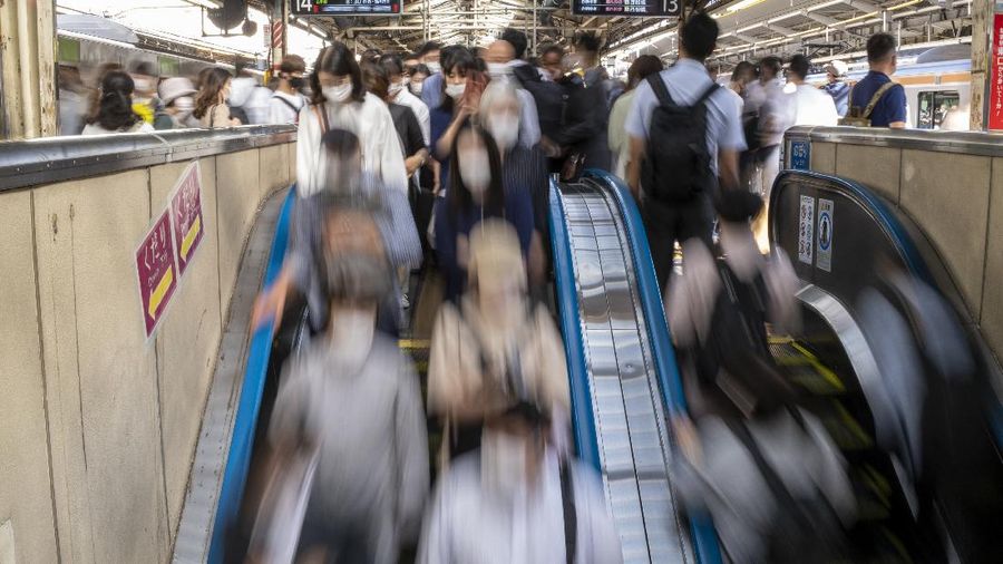 Passengers wait in a long line to get into JR Kawaguchi station in Kawaguchi, near Tokyo Friday, Oct. 8, 2021. Entry to the station was restricted due to aftermath of Thursday's strong earthquake. (Kyodo News via AP)