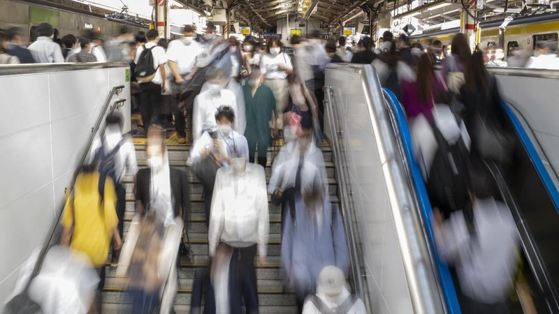 Passengers wait in a long line to get into JR Kawaguchi station in Kawaguchi, near Tokyo Friday, Oct. 8, 2021. Entry to the station was restricted due to aftermath of Thursday's strong earthquake. (Kyodo News via AP)