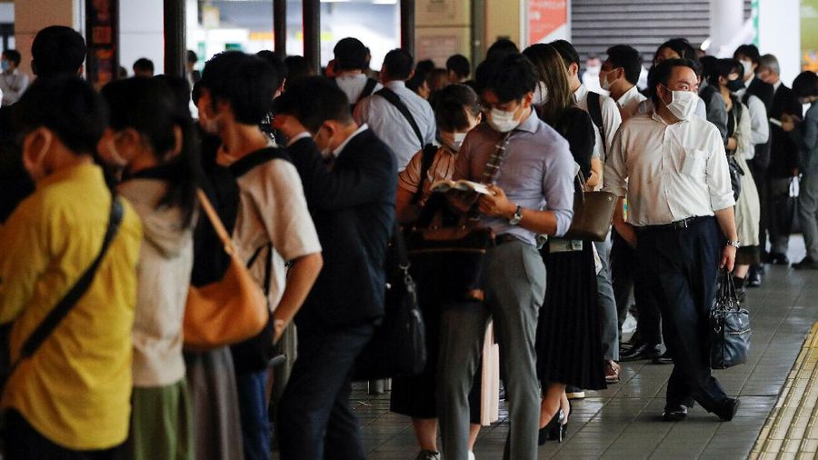 People wait in a line at a taxi stand outside of Shinagawa station, as some train services were suspended due to an earthquake, in Tokyo, Japan, October 8, 2021. REUTERS/Kim Kyung-Hoon