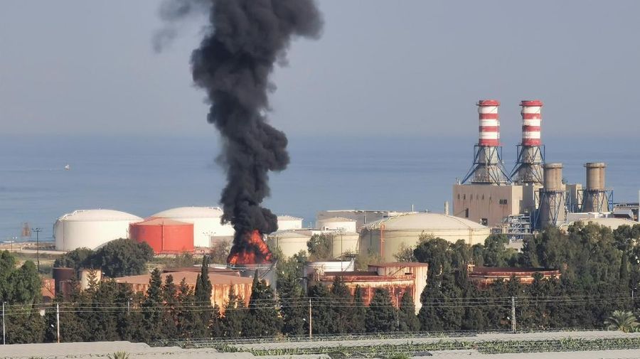 Firefighters work to extinguish a fire at an oil facility in the southern town of Zahrani, south of the port city of Sidon, Lebanon, Monday, Oct. 11, 2021. The cause of the huge fire was not immediately known. (AP Photo/Hassan Ammar)