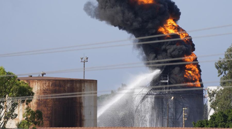 Firefighters work to extinguish a fire at an oil facility in the southern town of Zahrani, south of the port city of Sidon, Lebanon, Monday, Oct. 11, 2021. The cause of the huge fire was not immediately known. (AP Photo/Hassan Ammar)