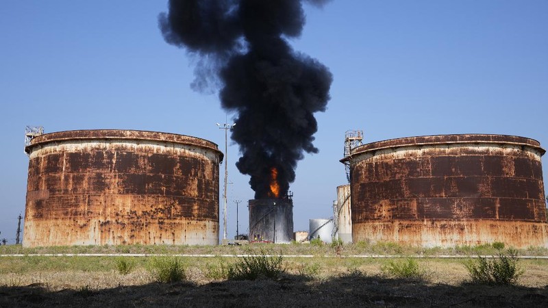 Firefighters work to extinguish a fire at an oil facility in the southern town of Zahrani, south of the port city of Sidon, Lebanon, Monday, Oct. 11, 2021. The cause of the huge fire was not immediately known. (AP Photo/Hassan Ammar)