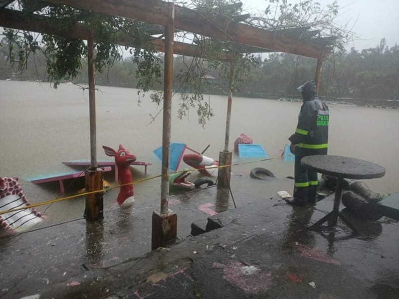 In this photo released by the Gonzaga Municipal Disaster Risk Reduction and Management Office, a resident is pulled along a rope as rescuers wait on the other side of a swollen river caused by heavy rains from Tropical Storm Kompasu in Gonzaga town, Cagayan province, northern Philippines, Monday Oct. 11, 2021. A number of people have been killed and others were reported missing in landslides and flash flood set off by a storm that barreled through the tip of the northern Philippines overnight then blew away Tuesday, officials said. (Gonzaga MDRRMO via AP)