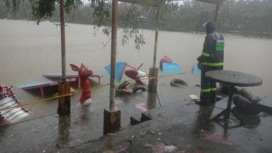 In this photo released by the Gonzaga Municipal Disaster Risk Reduction and Management Office, a resident is pulled along a rope as rescuers wait on the other side of a swollen river caused by heavy rains from Tropical Storm Kompasu in Gonzaga town, Cagayan province, northern Philippines, Monday Oct. 11, 2021. A number of people have been killed and others were reported missing in landslides and flash flood set off by a storm that barreled through the tip of the northern Philippines overnight then blew away Tuesday, officials said. (Gonzaga MDRRMO via AP)