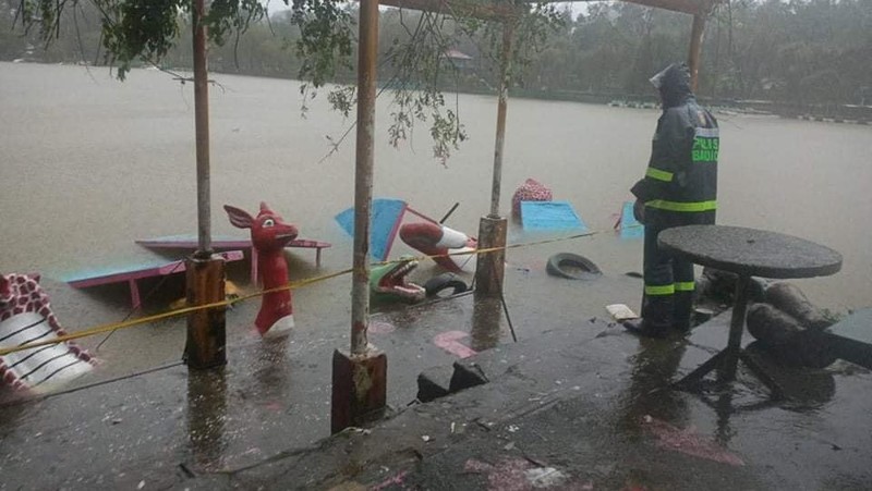 In this photo released by the Gonzaga Municipal Disaster Risk Reduction and Management Office, a resident is pulled along a rope as rescuers wait on the other side of a swollen river caused by heavy rains from Tropical Storm Kompasu in Gonzaga town, Cagayan province, northern Philippines, Monday Oct. 11, 2021. A number of people have been killed and others were reported missing in landslides and flash flood set off by a storm that barreled through the tip of the northern Philippines overnight then blew away Tuesday, officials said. (Gonzaga MDRRMO via AP)