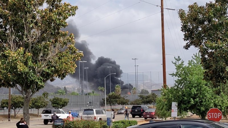 Fire crews work the scene of a small plane crash, Monday, Oct. 11, 2021, in Santee, Calif. At least two people were killed and two others were injured when the plane crashed into a suburban Southern California neighborhood, setting two homes ablaze, authorities said. (AP Photo/Gregory Bull)