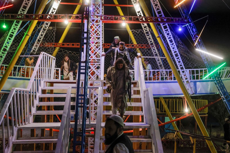 Taliban fighters get out of a vehicle as they take a day off to visit the amusement park at Kabul's Qargha reservoir, at the outskirts of Kabul, Afghanistan October 8, 2021. Picture taken October 8, 2021. REUTERS/Jorge Silva     TPX IMAGES OF THE DAY