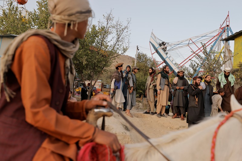 Taliban fighters get out of a vehicle as they take a day off to visit the amusement park at Kabul's Qargha reservoir, at the outskirts of Kabul, Afghanistan October 8, 2021. Picture taken October 8, 2021. REUTERS/Jorge Silva     TPX IMAGES OF THE DAY
