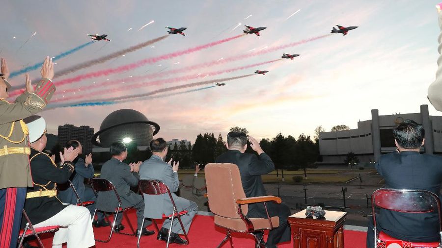North Korea's leader Kim Jong Un watches planes during a flypast at the Defence Development Exhibition, in Pyongyang, North Korea, in this undated photo releasåed on October 12, 2021 by North Korea's Korean Central News Agency (KCNA).      KCNA via REUTERS    ATTENTION EDITORS - THIS IMAGE WAS PROVIDED BY A THIRD PARTY. REUTERS IS UNABLE TO INDEPENDENTLY VERIFY THIS IMAGE. NO THIRD PARTY SALES. SOUTH KOREA OUT. NO COMMERCIAL OR EDITORIAL SALES IN SOUTH KOREA.