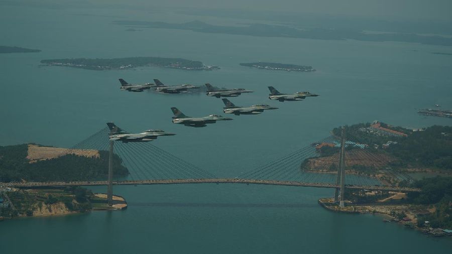 Pesawat F-16 Angkatan Udara Republik Singapura (RSAF) dan Angkatan Udara Indonesia (TNI AU) terbang dalam formasi di atas Marina Bay Sands di Singapura. (Tangapan Layar via mindef.gov.sg)