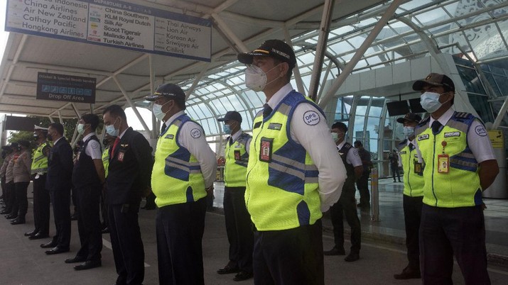 Bandara Internasional Ngurah Rai di Bali Bersiap Sambut Turis Airport security personnel line up during a briefing in preparation of the reopening of International Ngurah Rai Airport in Bali, Indonesia, Thursday, Oct. 14, 2021. The Indonesian resort island of Bali welcomed international travelers to its shops and white-sand beaches for the first time in more than a year Thursday - if they're vaccinated, test negative, hail from certain countries, quarantine and heed restrictions in public. (AP Photo/Firdia Lisnawati)