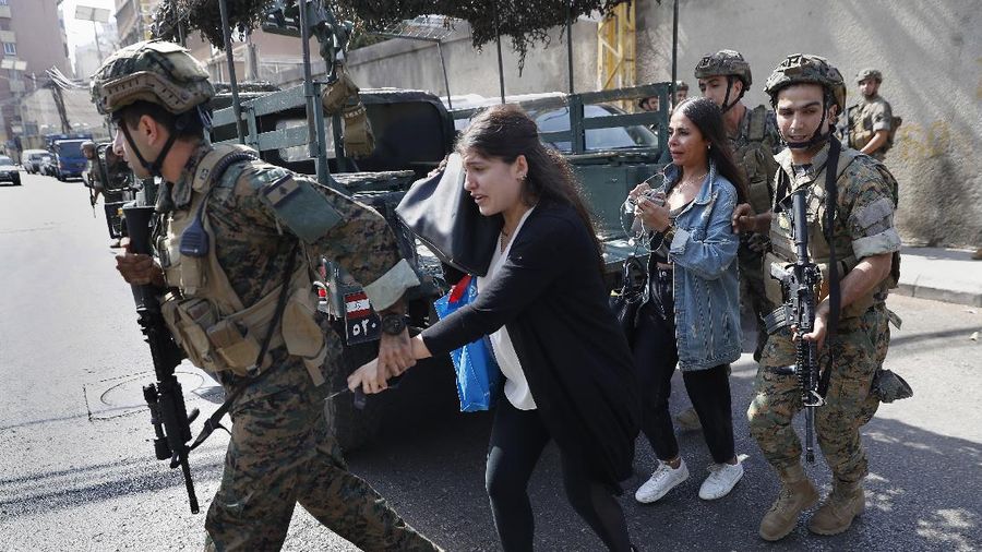A supporter of the Shiite Hezbollah and Amal groups burns posters that show the U.S. Ambassador to Lebanon Dorothy Shea, and Arabic that reads: 
