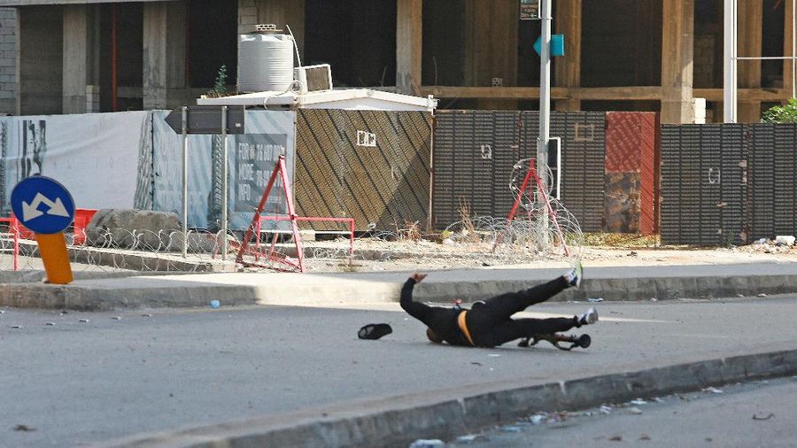 A supporter of the Shiite Hezbollah and Amal groups burns posters that show the U.S. Ambassador to Lebanon Dorothy Shea, and Arabic that reads: 