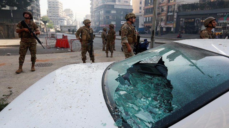 A supporter of the Shiite Hezbollah and Amal groups burns posters that show the U.S. Ambassador to Lebanon Dorothy Shea, and Arabic that reads: 