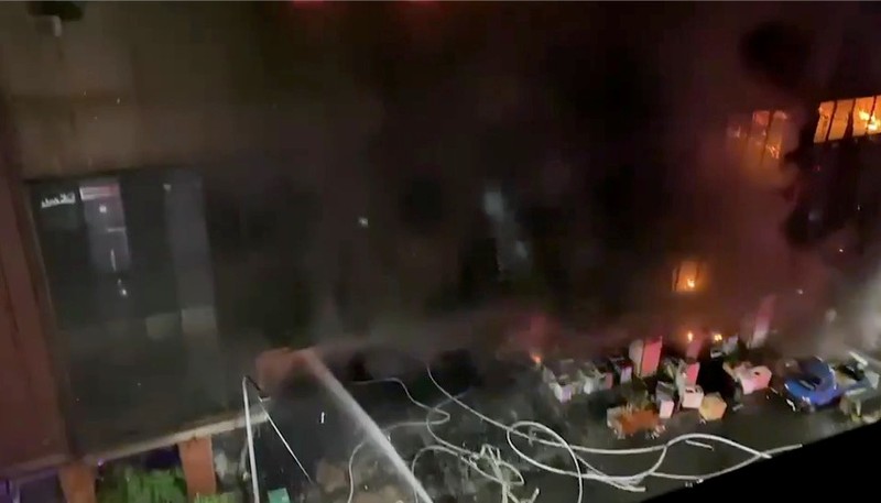 In this image taken from video by Taiwan's EBC, firefighters battle a blaze at a building in Kaohsiung, in southern Taiwan on Thursday, Oct. 14, 2021. A fire engulfed a 13-story building overnight in southern Taiwan, the island’s semi-official Central News Agency reported Thursday. (EBC via AP )