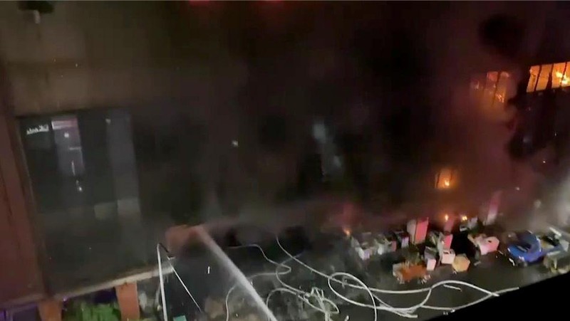 In this image taken from video by Taiwan's EBC, firefighters battle a blaze at a building in Kaohsiung, in southern Taiwan on Thursday, Oct. 14, 2021. A fire engulfed a 13-story building overnight in southern Taiwan, the island’s semi-official Central News Agency reported Thursday. (EBC via AP )