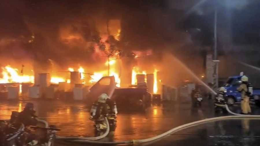 In this image taken from video by Taiwan's EBC, firefighters battle a blaze at a building in Kaohsiung, in southern Taiwan on Thursday, Oct. 14, 2021. A fire engulfed a 13-story building overnight in southern Taiwan, the island’s semi-official Central News Agency reported Thursday. (EBC via AP )