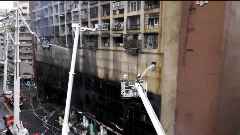 In this image taken from video by Taiwan's EBC, firefighters battle a blaze at a building in Kaohsiung, in southern Taiwan on Thursday, Oct. 14, 2021. A fire engulfed a 13-story building overnight in southern Taiwan, the island’s semi-official Central News Agency reported Thursday. (EBC via AP )