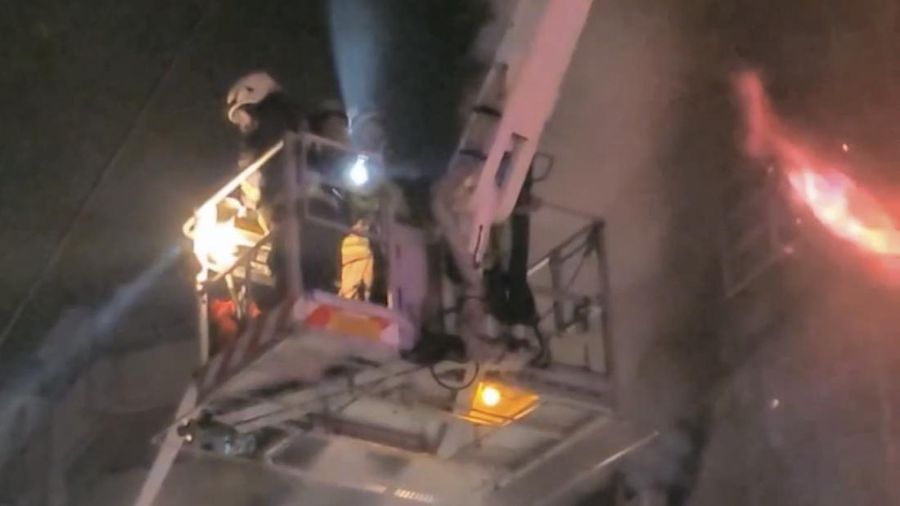 In this image taken from video by Taiwan's EBC, firefighters battle a blaze at a building in Kaohsiung, in southern Taiwan on Thursday, Oct. 14, 2021. A fire engulfed a 13-story building overnight in southern Taiwan, the island’s semi-official Central News Agency reported Thursday. (EBC via AP )