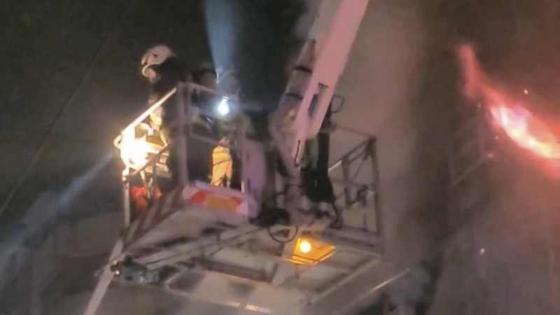 In this image taken from video by Taiwan's EBC, firefighters battle a blaze at a building in Kaohsiung, in southern Taiwan on Thursday, Oct. 14, 2021. A fire engulfed a 13-story building overnight in southern Taiwan, the island’s semi-official Central News Agency reported Thursday. (EBC via AP )