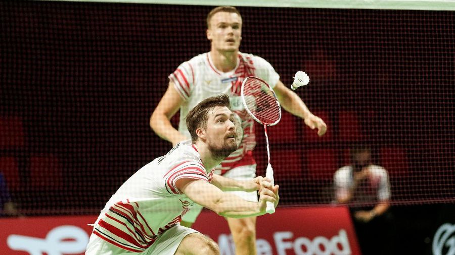 Indonesia's Anthony Sinisuka Ginting returns the shuttlecock to Denmark's Viktor Axelsen during a mens single match in the Thomas Cup mens team Badminton semifinal match between Denmark and Indonesia, in Aarhus, Denmark, Saturday Oct. 16, 2021. (Claus Fisker/Ritzau Scanpix via AP)